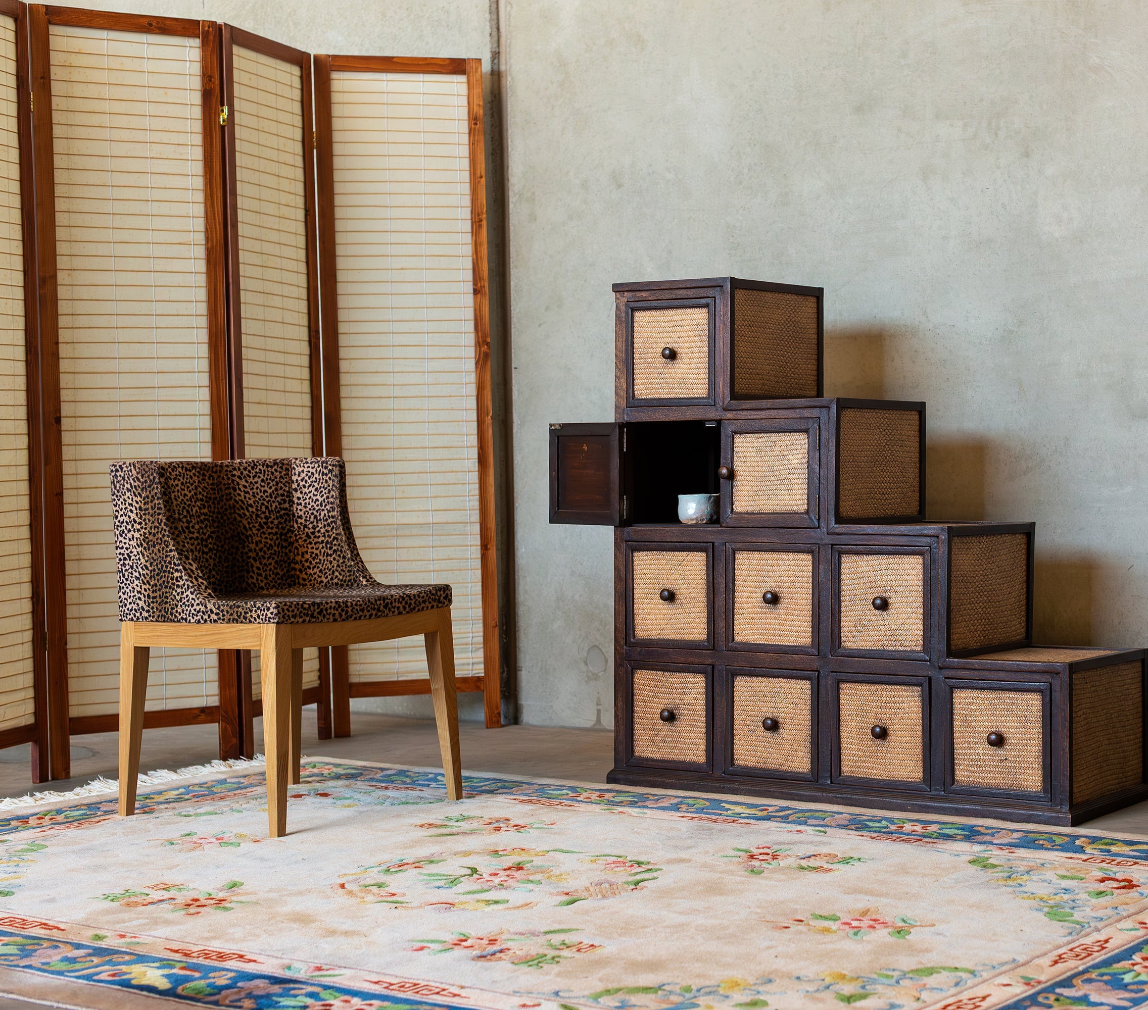 Vintage stepped cane storage cabinet with woven detailing